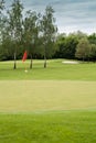 Red flag on a golf course Royalty Free Stock Photo