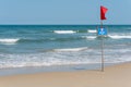 Da Nang, Vietnam: red flag, the graphic sign and inscription `No swimming` in English and Vietnamese