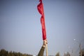 Red flag in hand. Workers` protest symbol red banner.