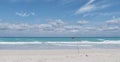 Red flag on sandy beach of Atlantic Ocean, Varadero, Cuba. Danger sign, no swimming.