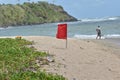 Red Flag on the Saline Bay, Toco, Trinidad and Tobago Royalty Free Stock Photo