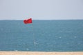 Red flag by the sea - warning sign Royalty Free Stock Photo