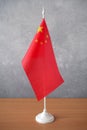 Red flag with stars stay in table, Flag of China Wave CloseUp, China stand on table