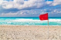 Red flag on a stormy beach Royalty Free Stock Photo