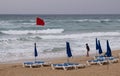 Red flag on the stormy beach. Dangerous for swimming. Unrecognized child on the coast Royalty Free Stock Photo