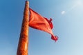 Red flag to develop on the background of blue sky Royalty Free Stock Photo