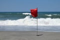 Red flag on tropical beach Royalty Free Stock Photo