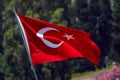 Red flag of Turkey waving n street on a green background Royalty Free Stock Photo