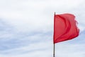 Red flag warning flags wind blue sky Royalty Free Stock Photo