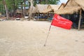 Red flag Warning Strong Current and Dangerous No Swimming in sea on Storm. Red flag flying on beach Royalty Free Stock Photo