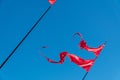Red flags are fluttering in the wind against the blue sky Royalty Free Stock Photo