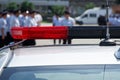 Red flashing light and antenna of a police car on a city street Royalty Free Stock Photo