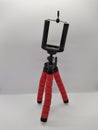 red and flexible tripod for phone on white background Royalty Free Stock Photo