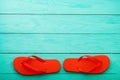 Red flip flops on blue wooden background. Summer holiday. Slippers on the beach. Copy space. Top view Royalty Free Stock Photo