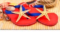 Red flip-flops, slippers with flowers on the wooden background