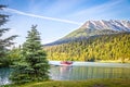 Red float plane parked on the waters of Upper Trail Lake on the Kenai Peninsula of Alaska USA framed by pine trees with blurred Royalty Free Stock Photo