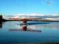 Red floatplane landing on the lake in Canada Royalty Free Stock Photo