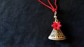 Red-flowered bell necklace on dark fabric background Royalty Free Stock Photo