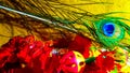 Red Flowers, Beautiful Unique Peacock Feather, Flute, Toy And Yellow Background. Happy Krishan Janmashtami Or Happy Radhaashtami. Royalty Free Stock Photo