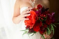 Red flowers in the bridal's hands Royalty Free Stock Photo