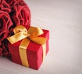 Red flowers and gift box with yellow ribbon Royalty Free Stock Photo