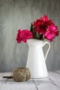 Red flowers in white jug Royalty Free Stock Photo