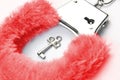 Red fluffy handcuffs Royalty Free Stock Photo