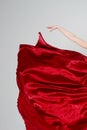 Red flying silk fabric and dancer`s hand.Passion and tango. Royalty Free Stock Photo