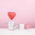 The red foiled chocolate heart stick with small watering can Royalty Free Stock Photo