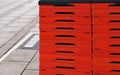 Red foldable plastic boxes on sidewalk Royalty Free Stock Photo