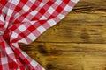 Red folded checkered napkin on rustic wooden kitchen table. Top view, copy space Royalty Free Stock Photo