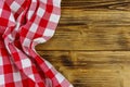 Red folded checkered napkin on rustic wooden kitchen table. Top view, copy space Royalty Free Stock Photo