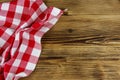Red folded checkered napkin on rustic wooden kitchen table. Top view, copy space Royalty Free Stock Photo