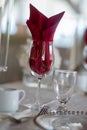 Red folded napkin in a wine glass, a table setting design idea Royalty Free Stock Photo