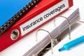 Red folder with insurance coverages documents