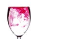 Red food coloring diffuse in water inside wine glass Royalty Free Stock Photo
