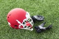 Red football helmet with balck gloves on the field Royalty Free Stock Photo