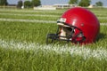 Red football helmet low angle on a grass field with stripes Royalty Free Stock Photo
