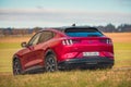 Red Ford Mustang Mach E on swiss rural roads