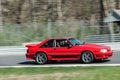 Red Ford Mustang in Motion on Race Track