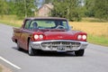 Red Ford Thunderbird Hardtop 1960 on the Road Royalty Free Stock Photo