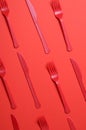 Red Forks and Knives on Bright Orange Background, Single Use Cutlery Royalty Free Stock Photo