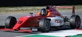 Red formula racing car close up action on motor sport racetrack
