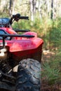 Red Four Wheeled ATV in the Forest