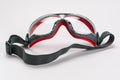 Red frame working goggles with black elastic strap on white background Royalty Free Stock Photo