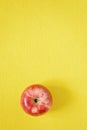 Red fresh apple on a yellow background. Close-up Royalty Free Stock Photo