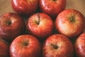 Red fresh apples as background. Close up view of heap of delicious apples as texture and background.