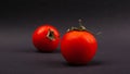 Red fresh juicy cherry tomatoes on a black background close-up, vegetable Royalty Free Stock Photo