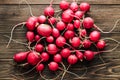 red fresh radish top view on a background of wooden boards.