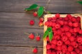 Red fresh raspberries basket on brown rustic wood background Royalty Free Stock Photo